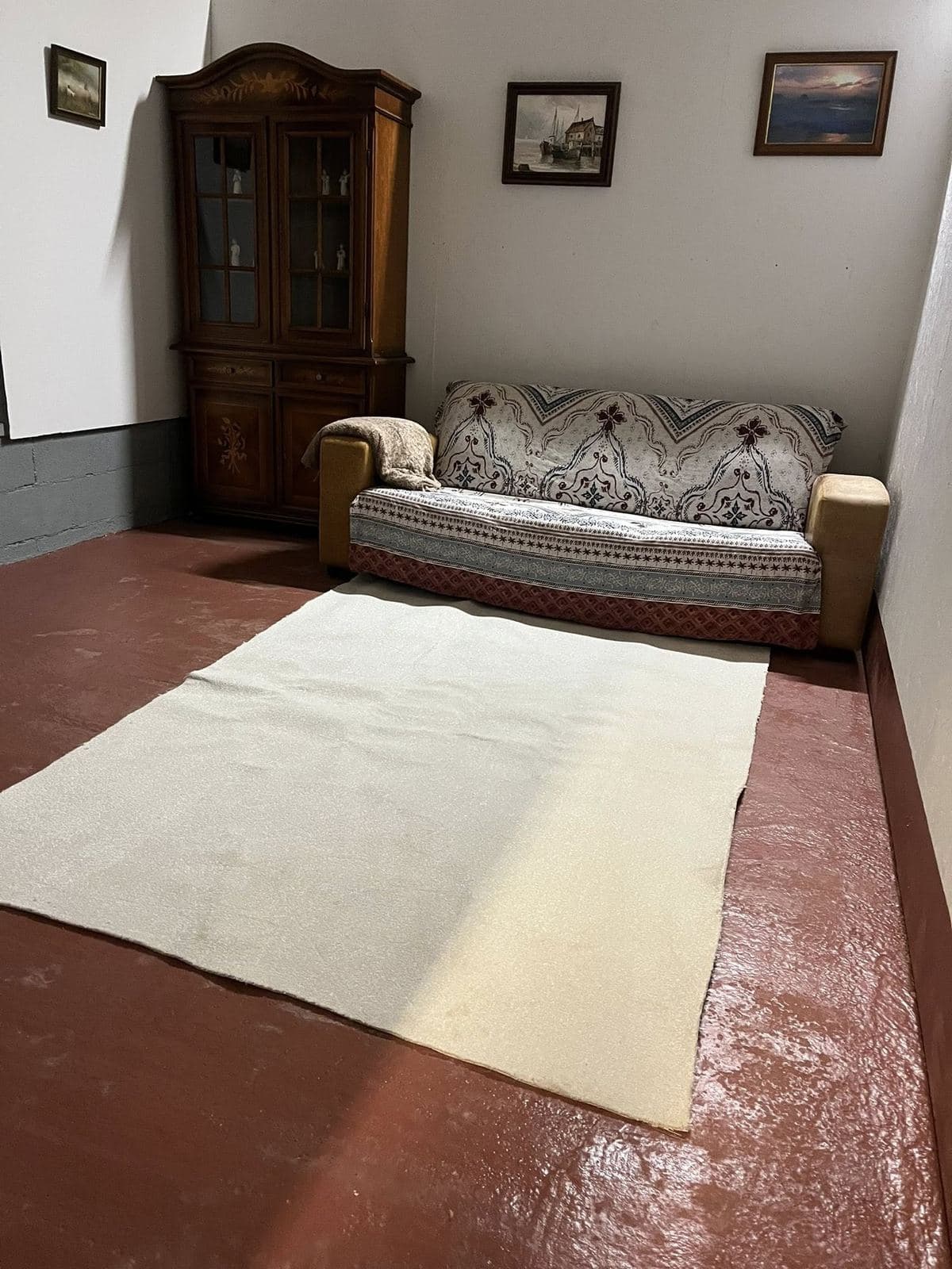 Tresmeer sofa room — Victorian tapestry sofa, antique pine dresser, framed maritime art, terracotta floor